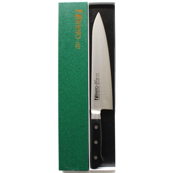 A chef knife displayed in a green box