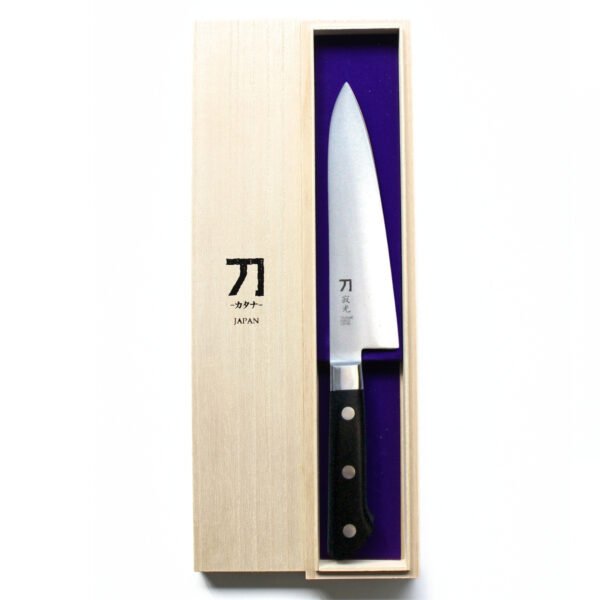 A chef knife displayed in a paulownia wood box