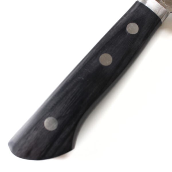 A kitchen knife focusing on its laminated wooden handle