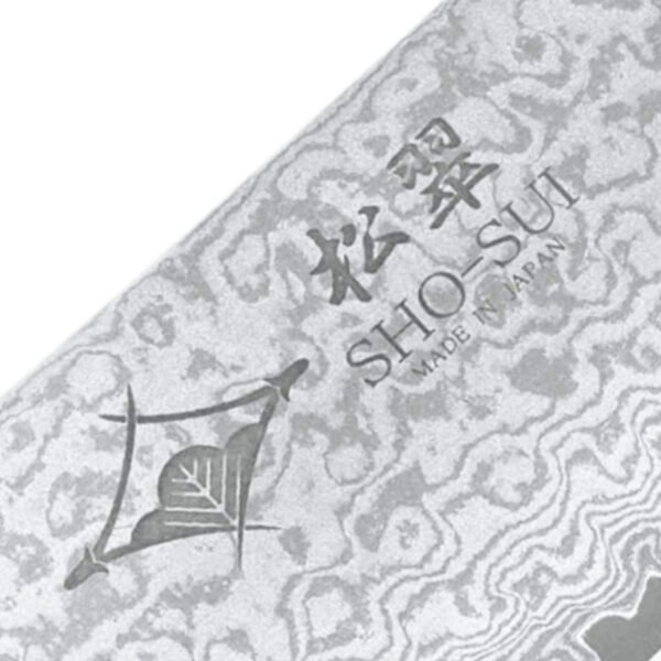 A kitchen knife focusing on its logo on the Damascus blade