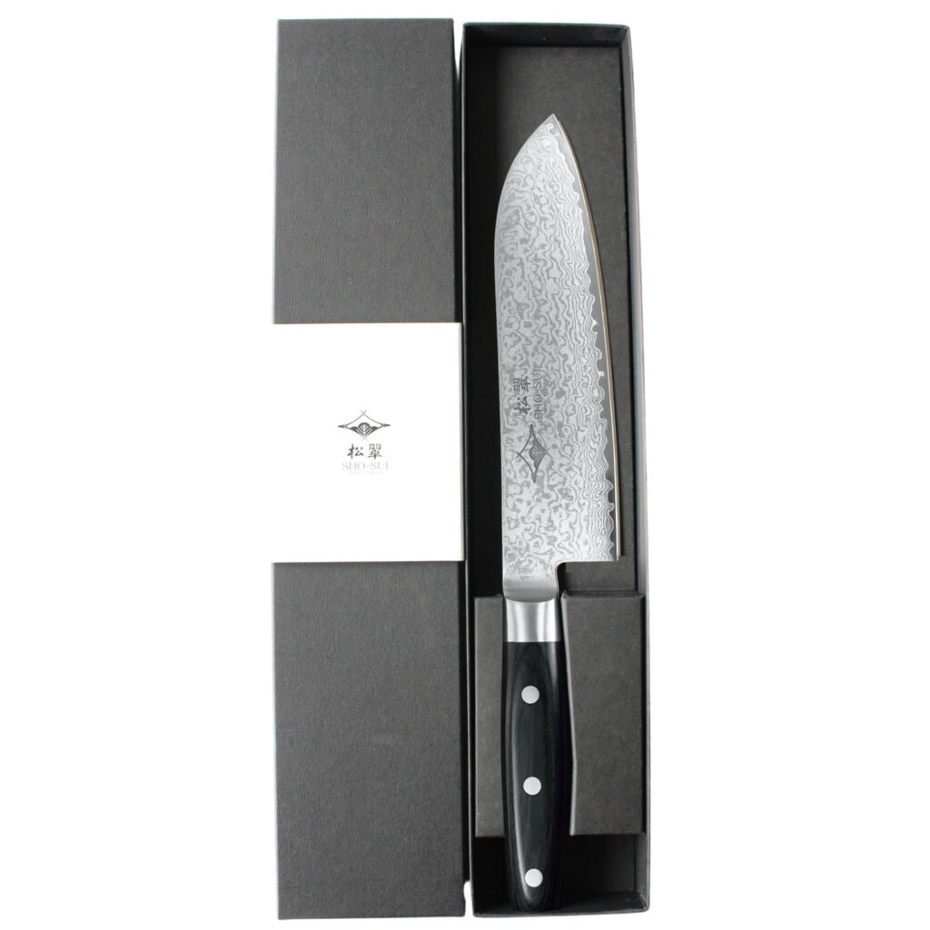 A Damascus all purpose knife displayed in a black box