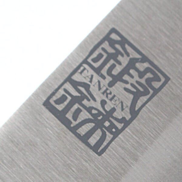 A kitchen knife focusing on its logo on the blade