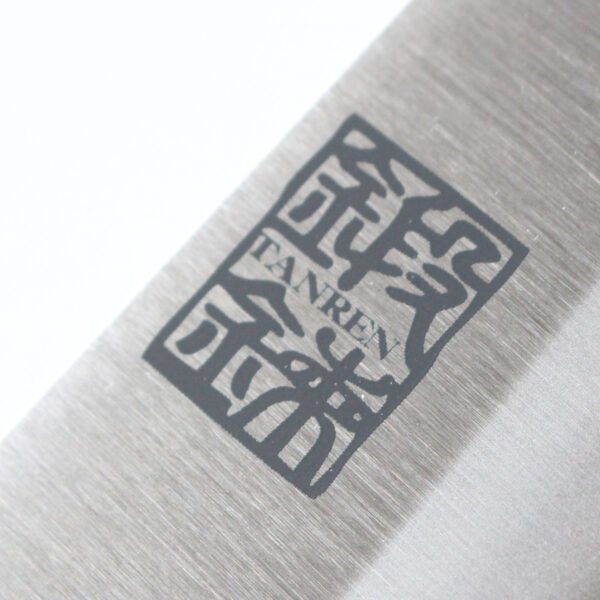 A kitchen knife focusing on its logo on the blade