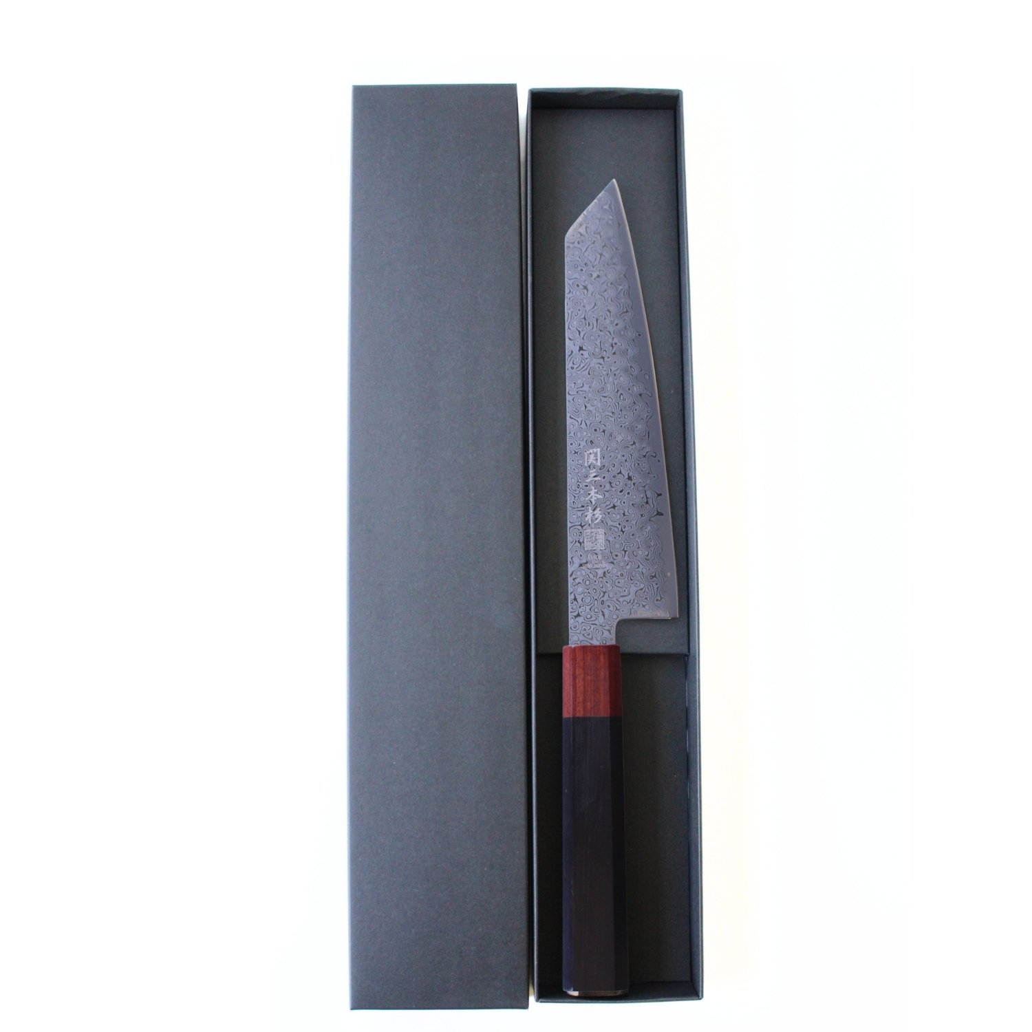 A Damascus all purpose knife displayed in a box