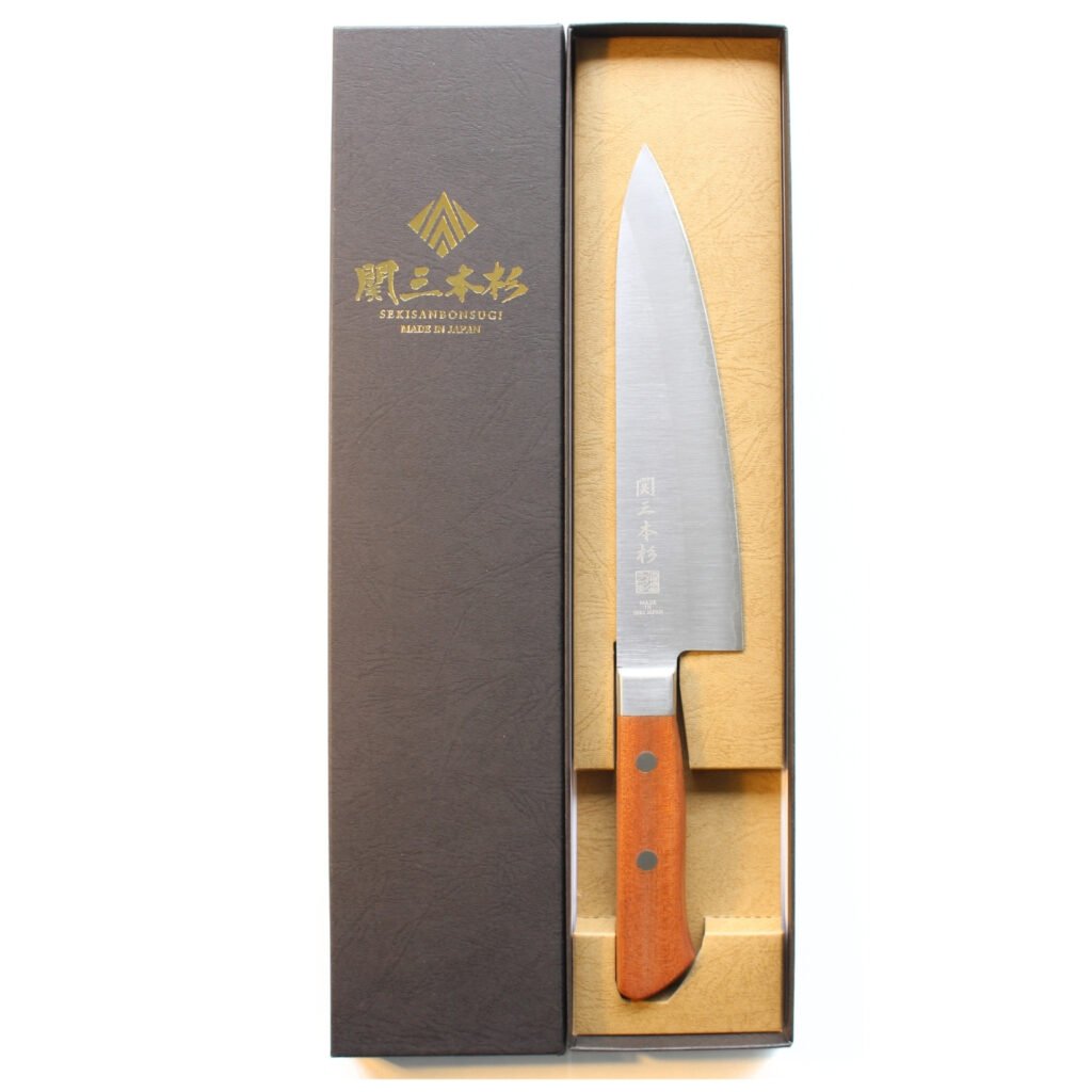 A chef knife displayed in a black box