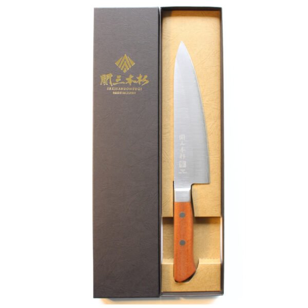 A chef knife displayed in a black box