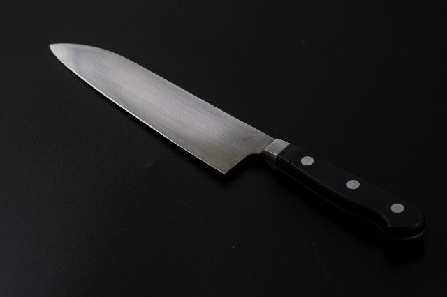 An image of an all-purpose knife placed diagonally against a black background.