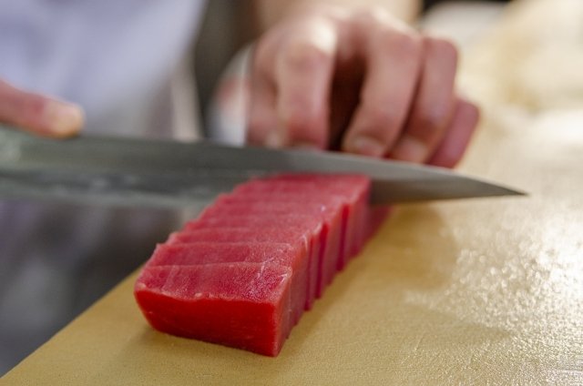 Slicing tuna with a kitchen knife