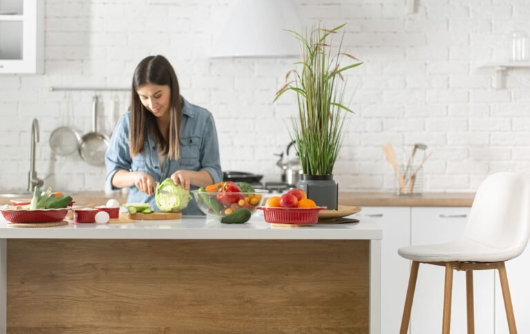 A young woman is cutting vegetables in the kitchen