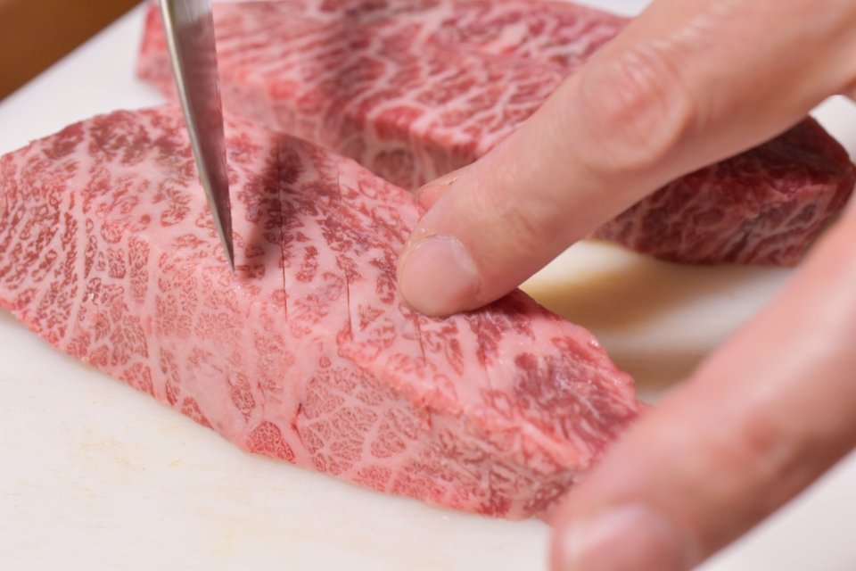 scoring beef with a kitchen knife