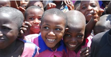 Group of African children smiling and looking happy outdoors