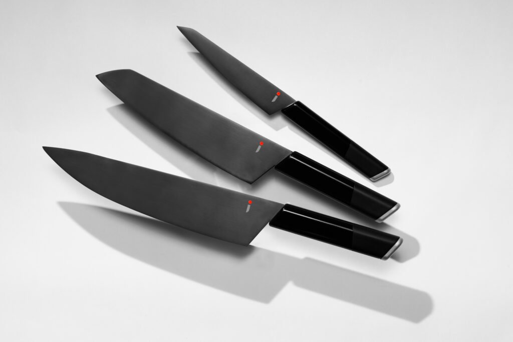 Three knives evenly arranged against a gray background