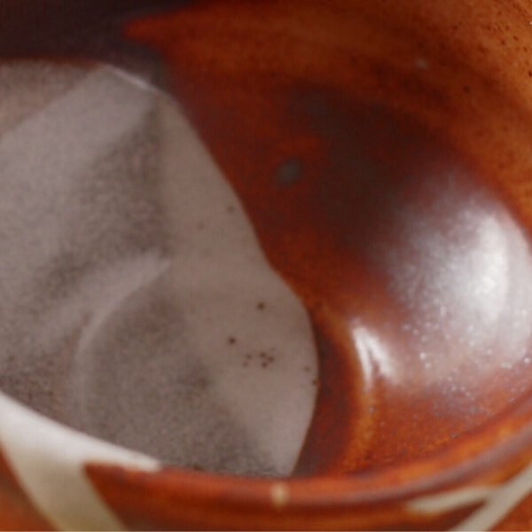 Close-up view of the matcha bowl's surface, showing its glaze and texture.