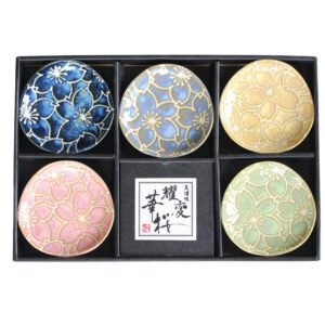 Top view of a gift set of five small plates in a box