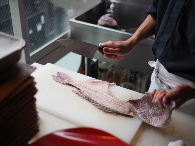 Chef Preparing Fish Using a Traditional Deba Knife