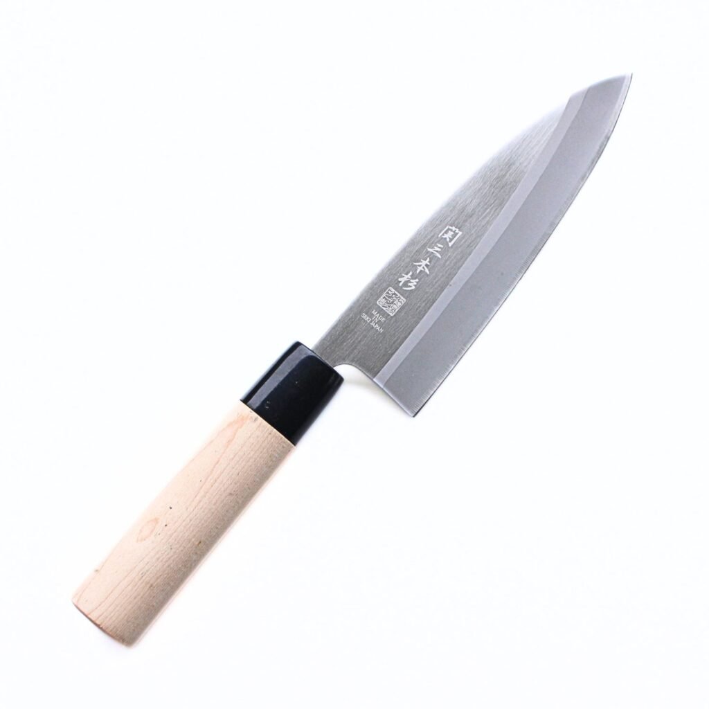 A Deba knife displayed diagonally, showing the entire knife