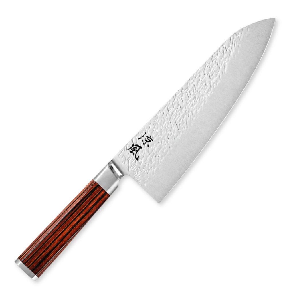 A Damascus chef's knife displayed diagonally, showing the entire knife